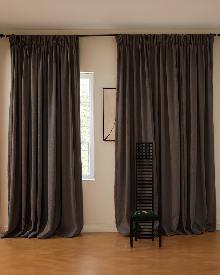 Dark grey soft textured wool blend custom drapery with pleated header, creating elegant window treatments.