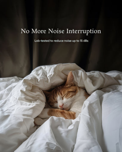 Orange & white cat sleeping peacefully under white blankets, dark soundproof thermal blackout custom curtains in background.