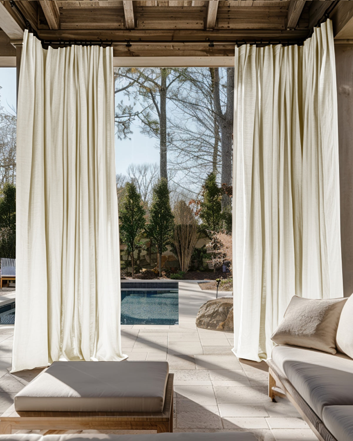 Lightweight Noah Linen Look custom outdoor curtains draping elegantly on a patio pergola, with a pool and outdoor lounge visible.