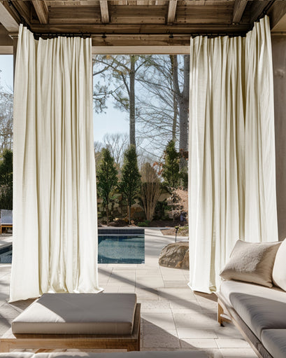Lightweight Noah Linen Look custom outdoor curtains draping elegantly on a patio pergola, with a pool and outdoor lounge visible.