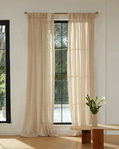 Elegant beige linen blend sheer custom curtains with gathered headers on a large window for privacy & light control.