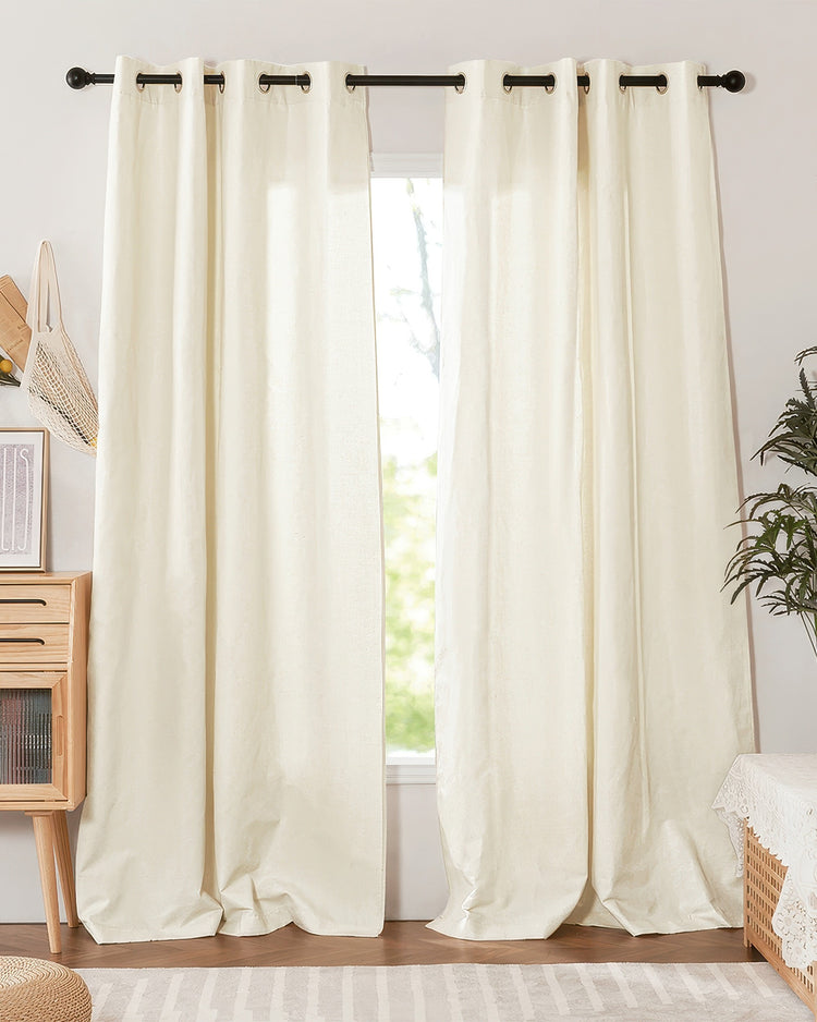 Cream Nara Linen & Cotton Blend lightweight custom curtain drapes with grommet header on a black rod, pooling on floor.