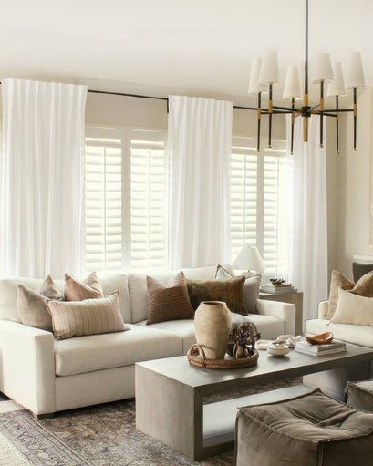 Sophisticated living room showcasing Nara Linen & Cotton Blend lightweight custom curtains over plantation shutters, balancing light & privacy.