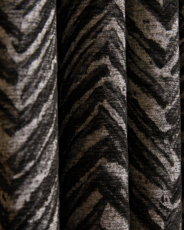 Close-up of black and silver Aztec linen blend custom curtain fabric with a zig-zag woven pattern & rich texture for elegant drapery.