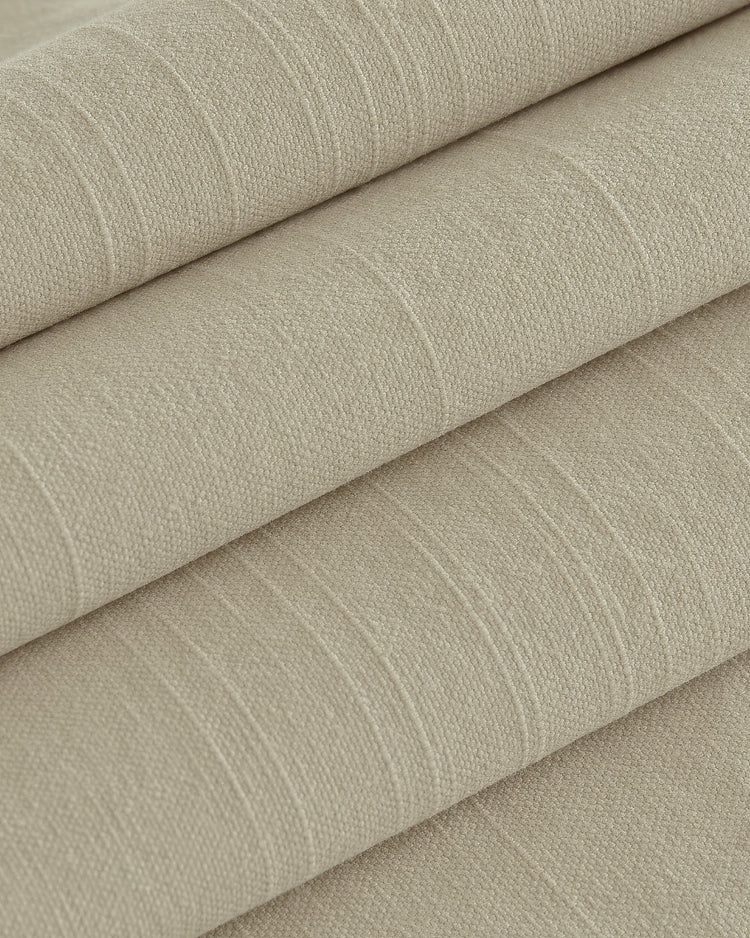 Textured close-up of Nara lightweight custom linen & cotton blend curtain fabric, folded in natural beige for sophisticated home decor.