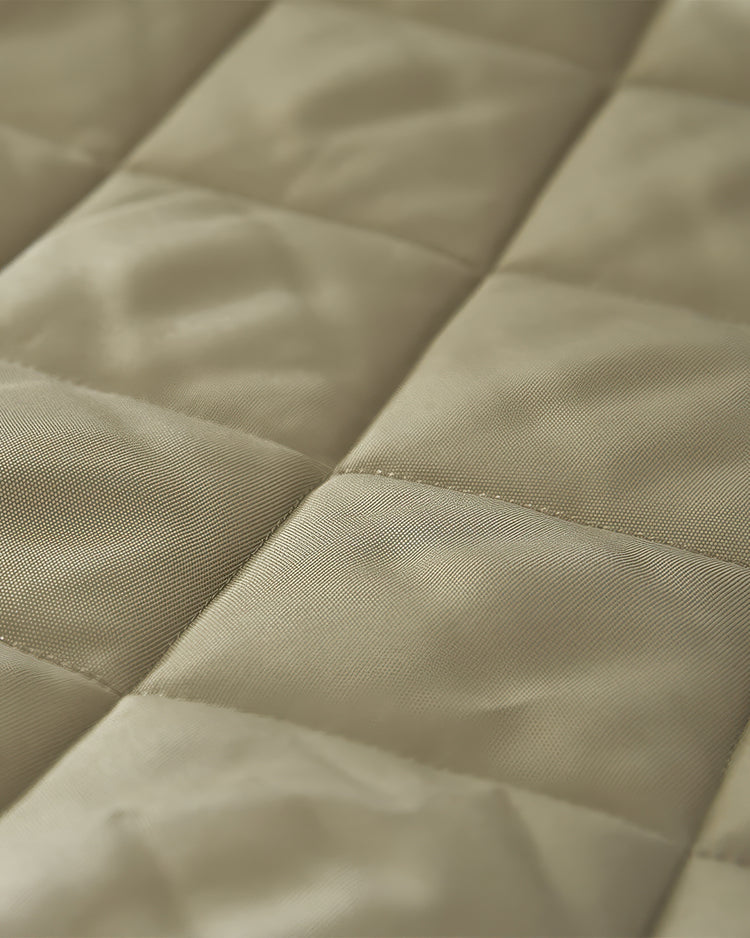 Close-up of the quilted, light beige Oxford thermal insulated fabric, highlighting its rich texture and stitching for custom door curtains.