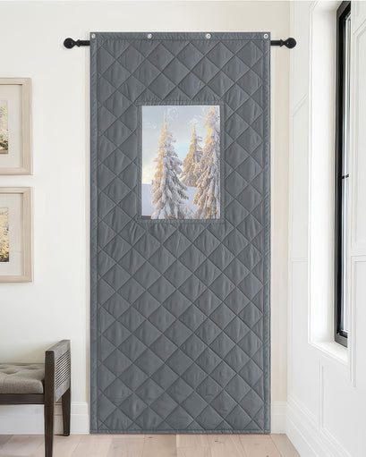 Dark gray quilted Oxford custom door curtain featuring a PVC clear window with snowy trees. Thermal insulated & soundproof window treatment.