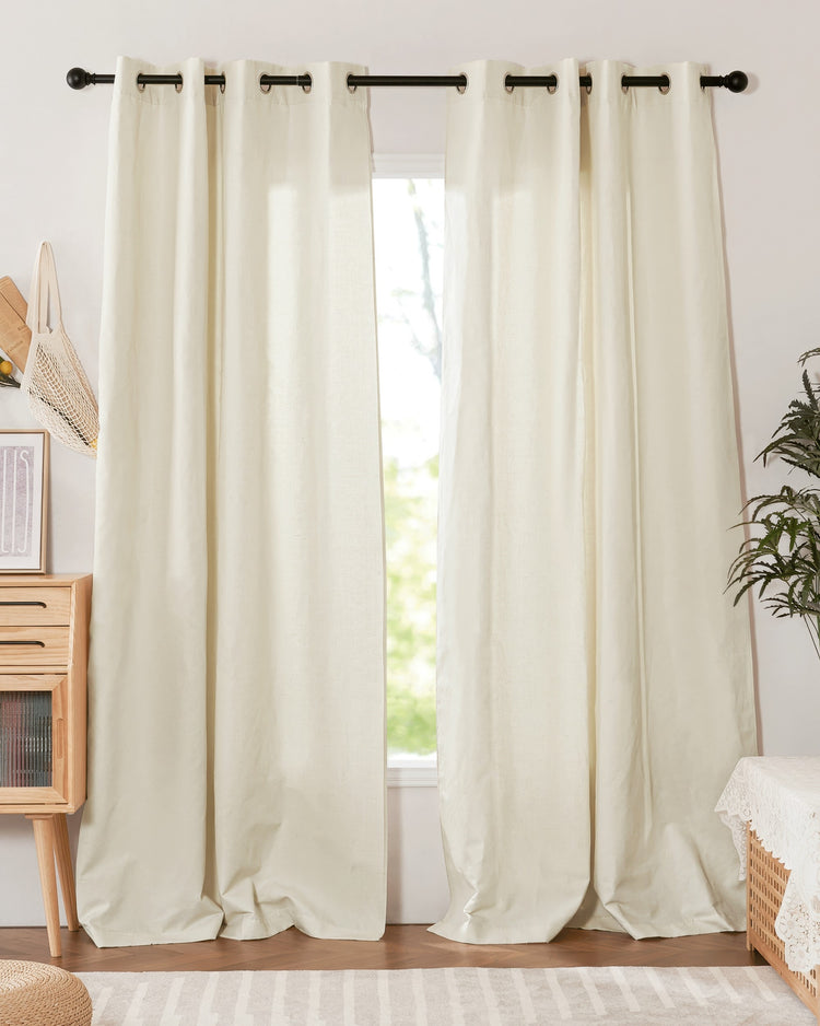 Two off-white Nara linen & cotton blend custom curtains with grommet header style, creating a lightweight window treatment.