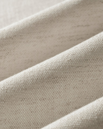 Close-up of Sally linen blend custom curtain fabric in natural beige, highlighting its woven texture & subtle folds for luxurious window treatments.
