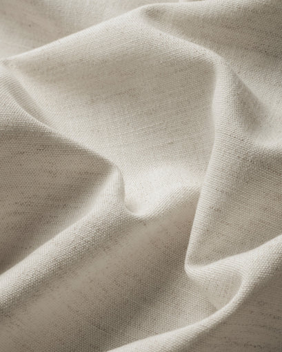 Textured close-up of light beige Sally linen blend custom curtain fabric with natural slubs and soft folds for elegant drapery.