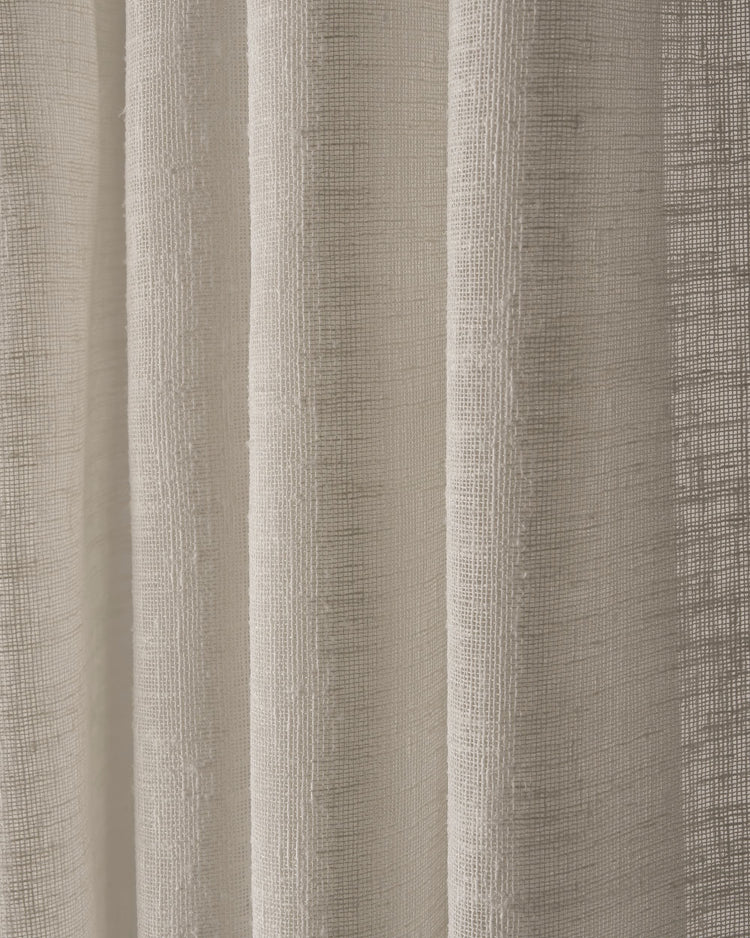 Close-up of light-filtering Sunveil linen sheer custom curtain fabric with visible woven texture and soft folds.