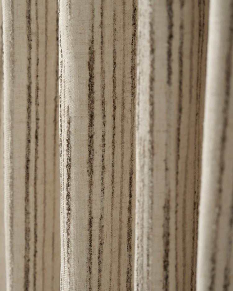 Close-up of Sahara Linen Blend patterned custom drapery fabric, showcasing its natural texture and irregular vertical stripes.