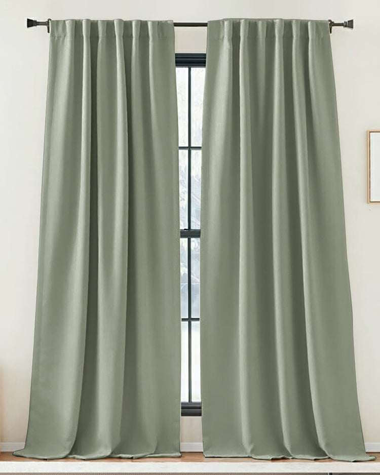 Soft sage green custom linen-look curtains with a gathered top on a dark rod, enhancing sophisticated home aesthetics.