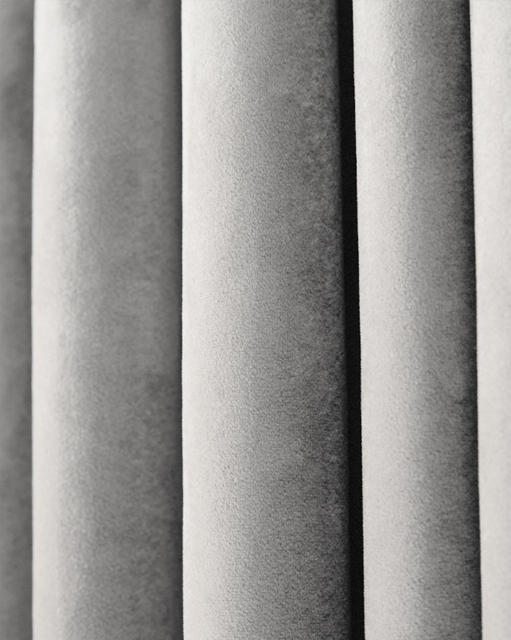 Luxurious Moonlit Velvet custom curtain close-up, highlighting plush silver-grey fabric texture and soft pleats.