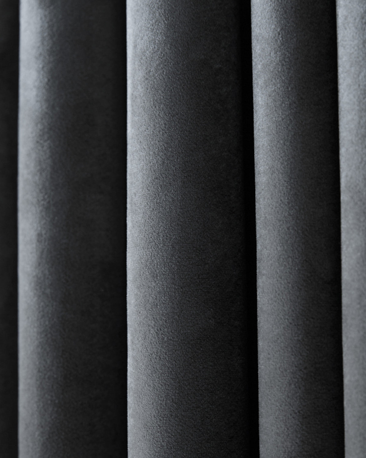 Close-up of luxurious dark grey Moonlit Velvet custom curtain fabric with soft, rich texture and elegant vertical folds.