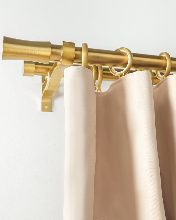 Silent Glide Roman Bronze double curtain rod with rings and elegant flared finial, holding light beige custom drapery.
