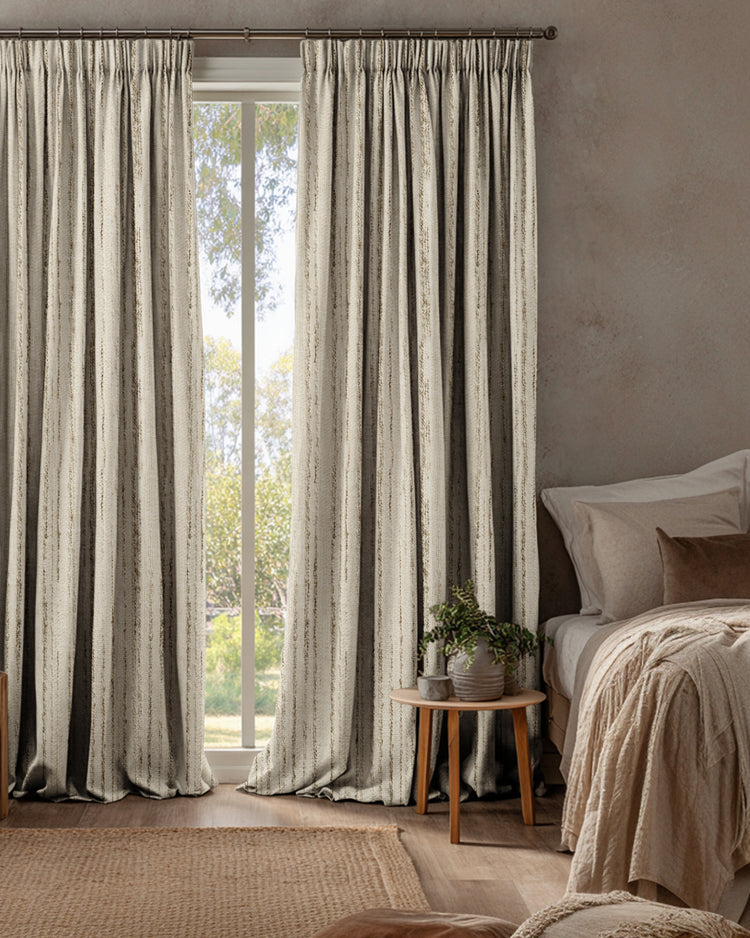 Floor-length Sahara linen blend custom curtains with natural jacquard pattern in a luxurious bedroom for sophisticated window treatments.