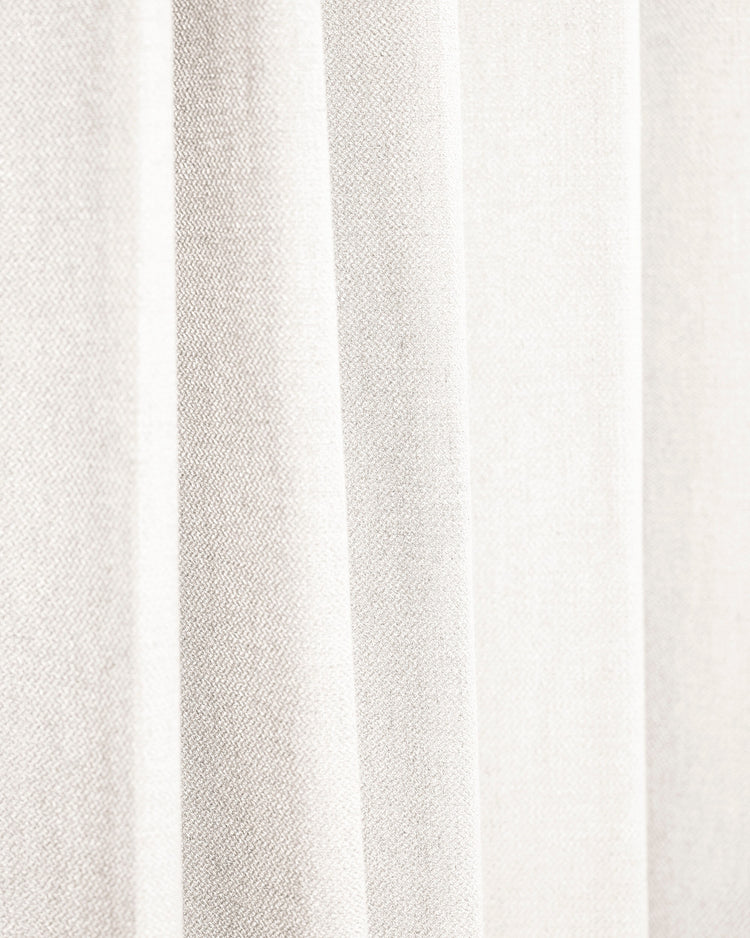 Close-up of Iris textured custom drapery in a light natural shade, showing its exquisite weave and elegant folds.