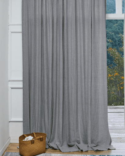 Tahiti 100% pure linen custom drapery, charcoal grey, pooling elegantly on wood floor, for sophisticated window privacy.