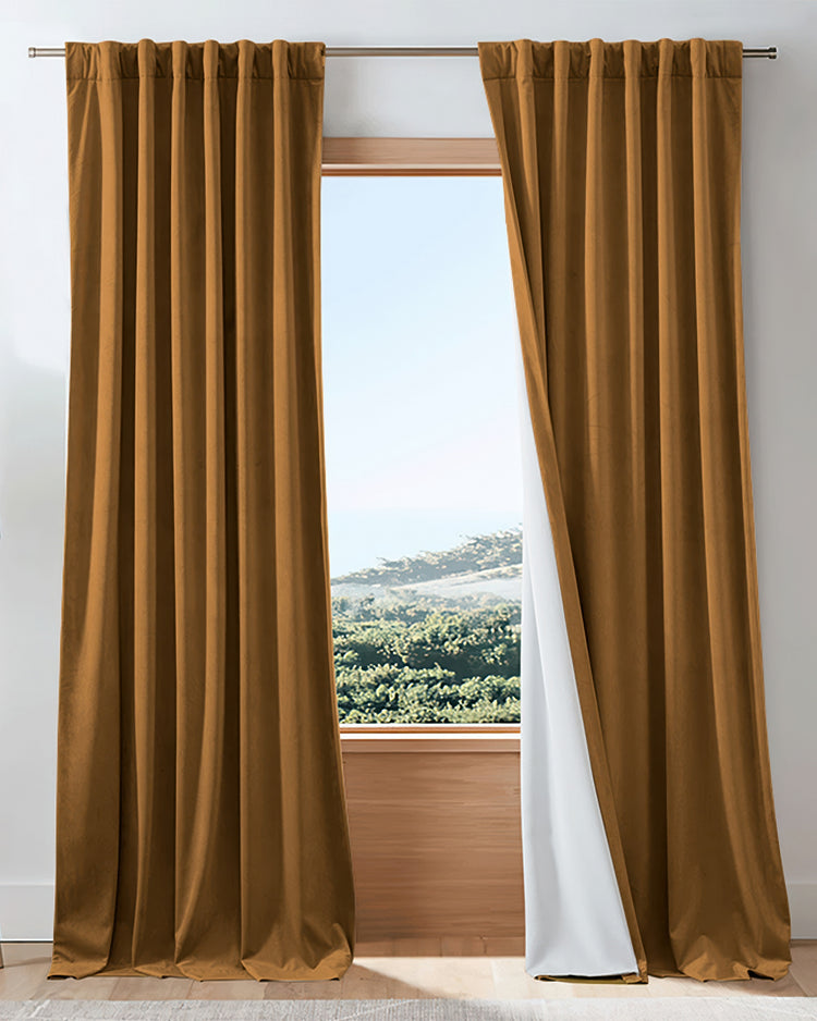 Elegant golden brown velvet 100% blackout custom drapery showcasing white thermal lining for soundproof window treatments.