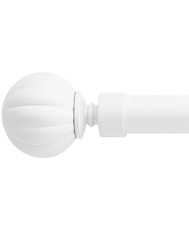 White reeded ball finial on an adjustable curtain rod, showcasing elegant details for home decor.