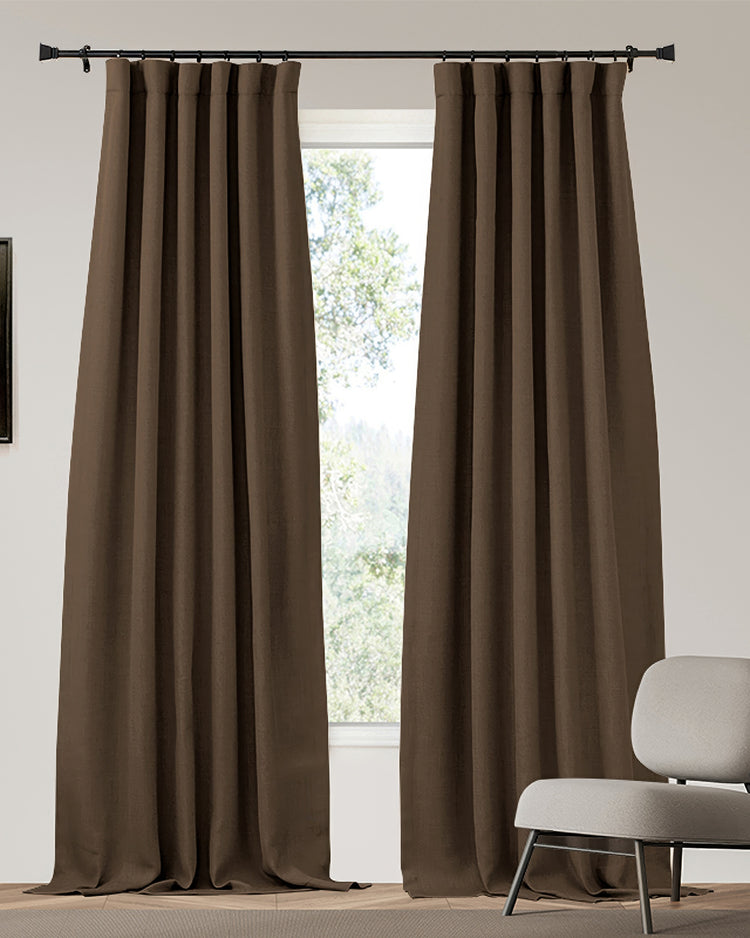 Elegant brown heavyweight custom blackout curtains with pleated header, linen-look texture, partially open revealing natural light.