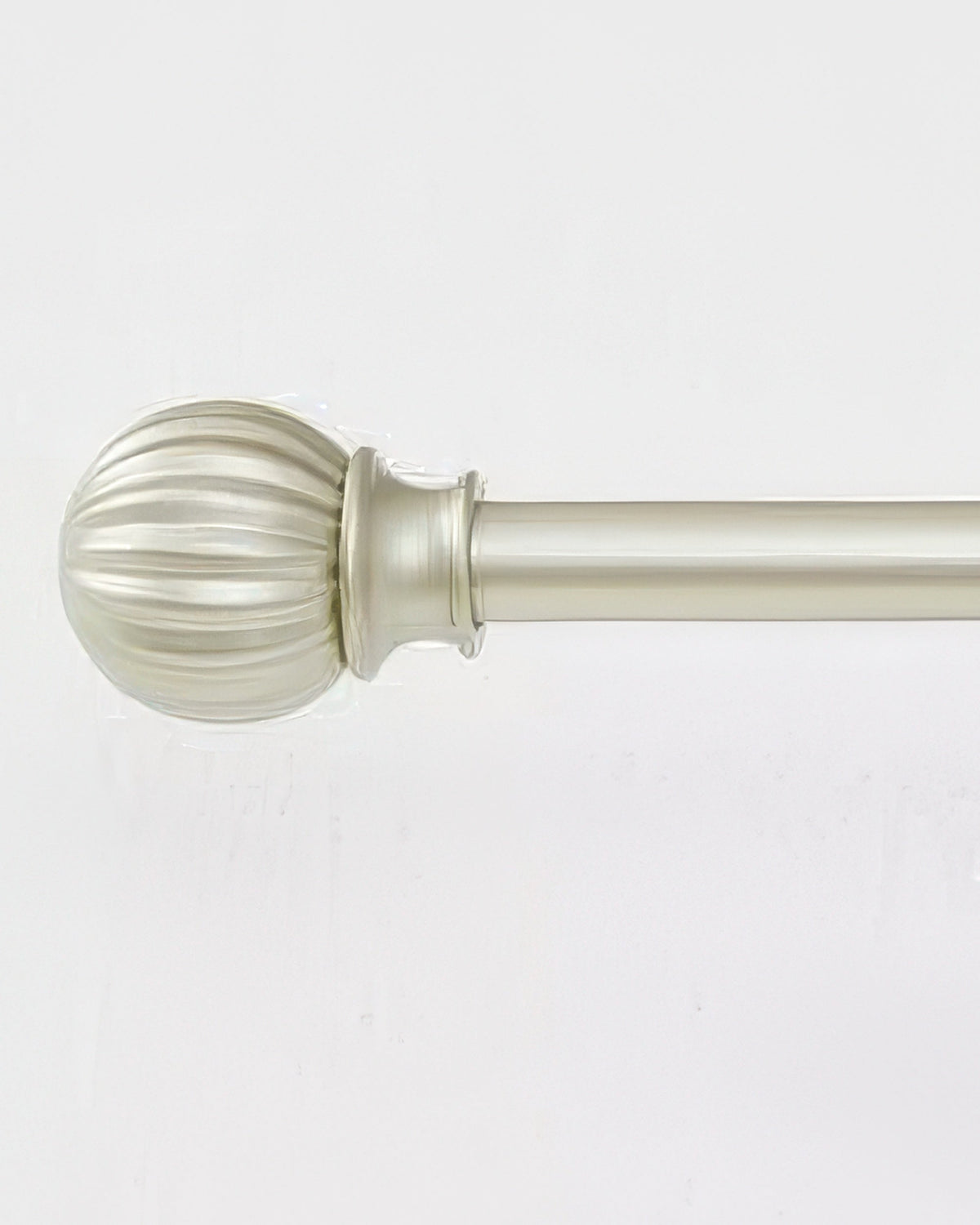 Close-up of a brushed brass adjustable curtain rod with an elegant, fluted round finial for sophisticated home decor.