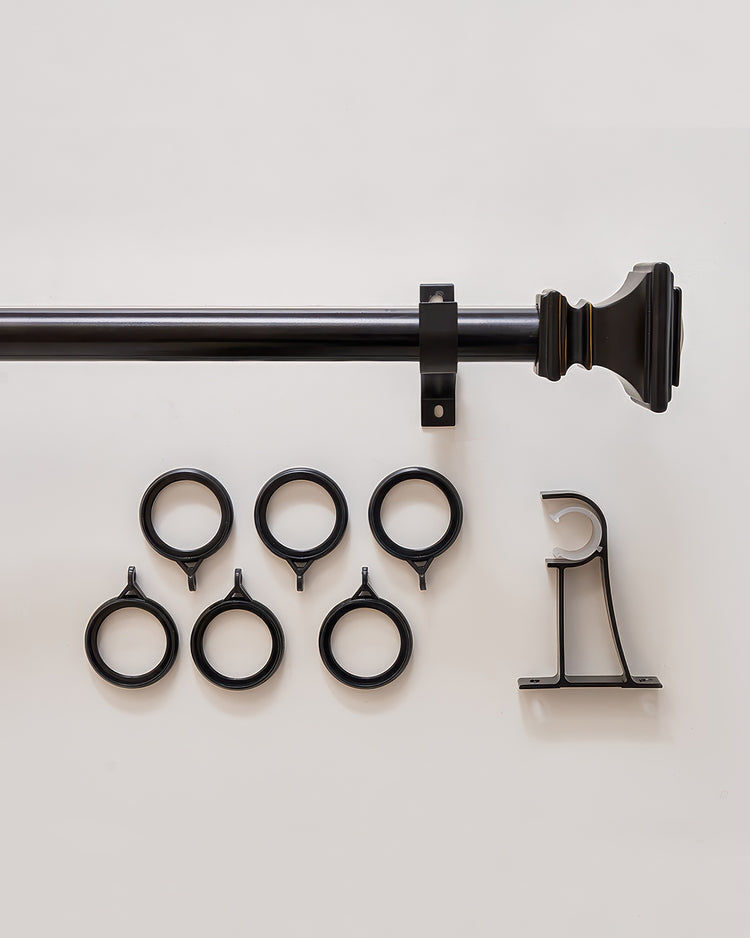 Black custom curtain rod featuring a distinct Roman Square finial, a support bracket, and five matching curtain rings.