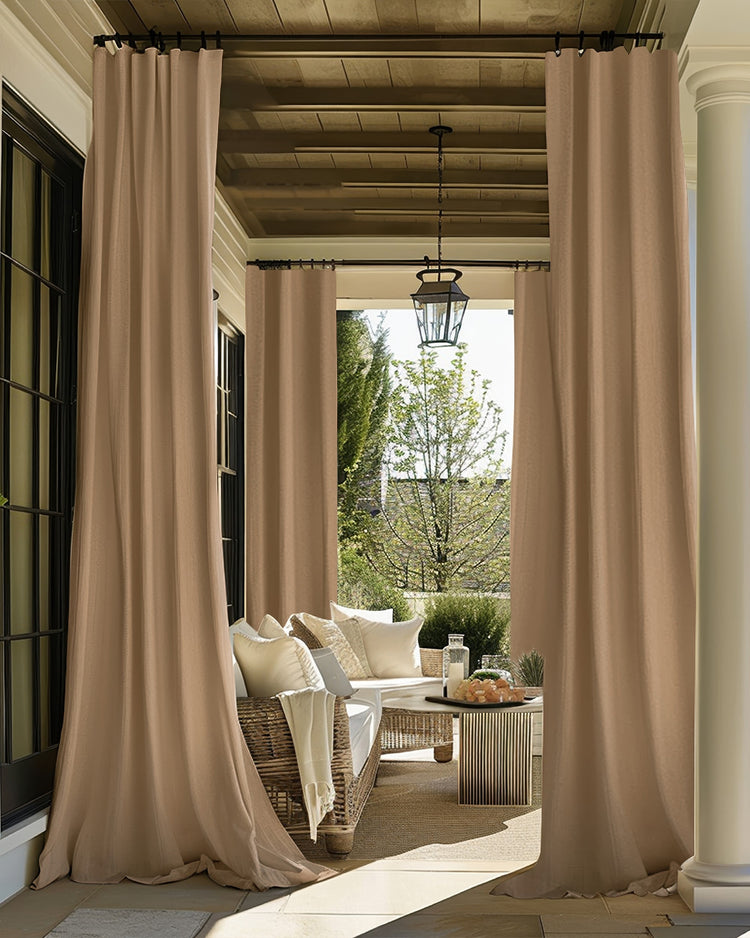 Long tan FadeShield Pro blackout outdoor curtains define a stylish patio lounge area, ensuring privacy & sun protection.