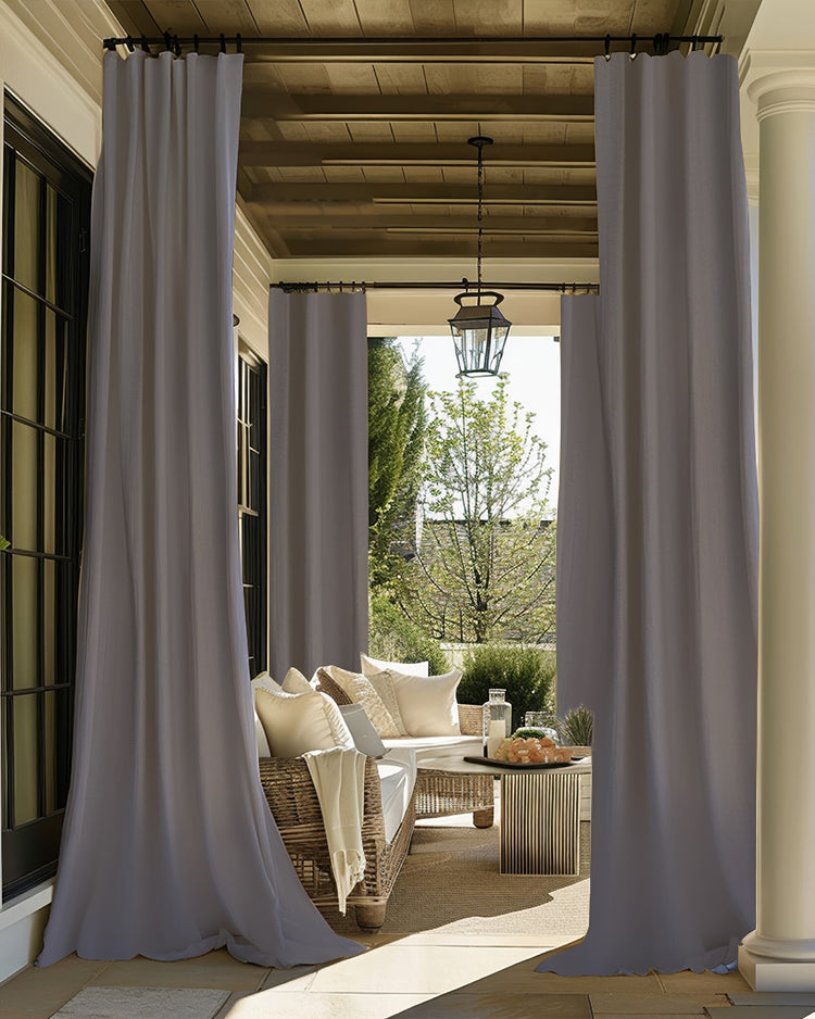 FadeShield Pro™ grey outdoor blackout curtains on a luxurious patio, enhancing privacy & light control for relaxation.