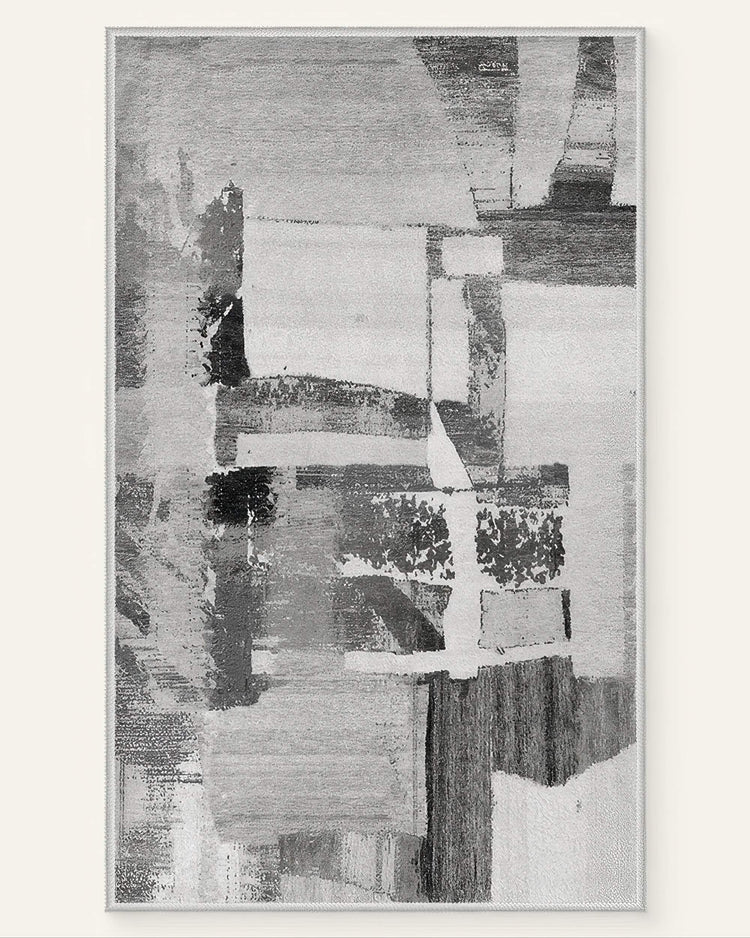 Abstract geometric Tara Dark Gray washable area rug with a vintage distressed pattern in shades of gray & off-white.