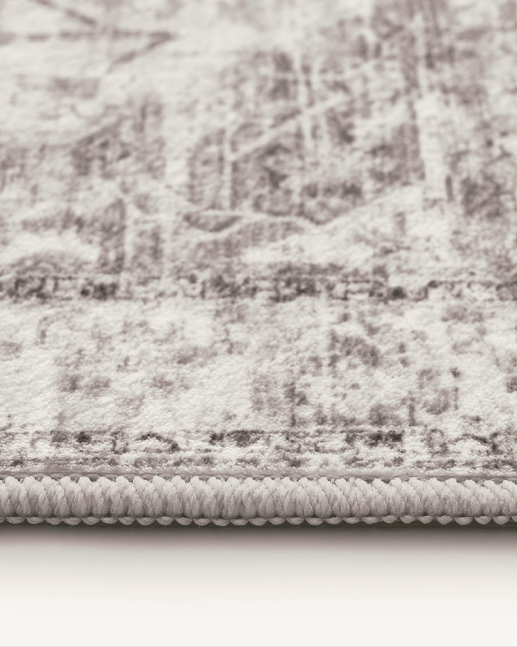 Close-up of Diana's Garden deep taupe washable area rug, showcasing plush texture, intricate pattern, and durable edge.