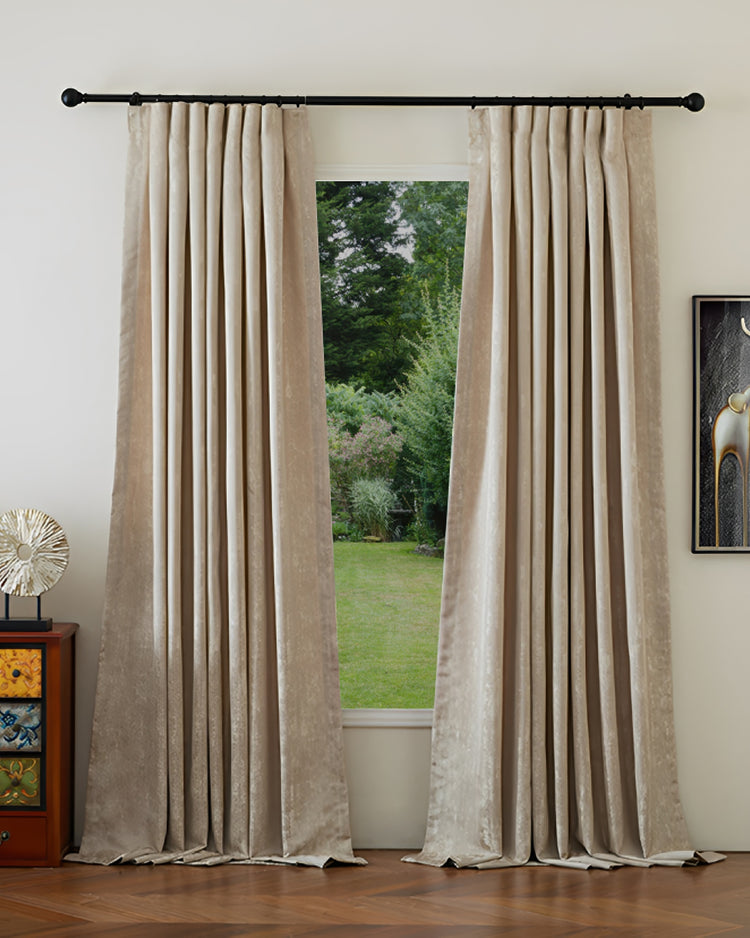 Custom Glimmer champagne linen blend blackout curtains, showcasing textured fabric & elegant pleats, framing a lush garden.