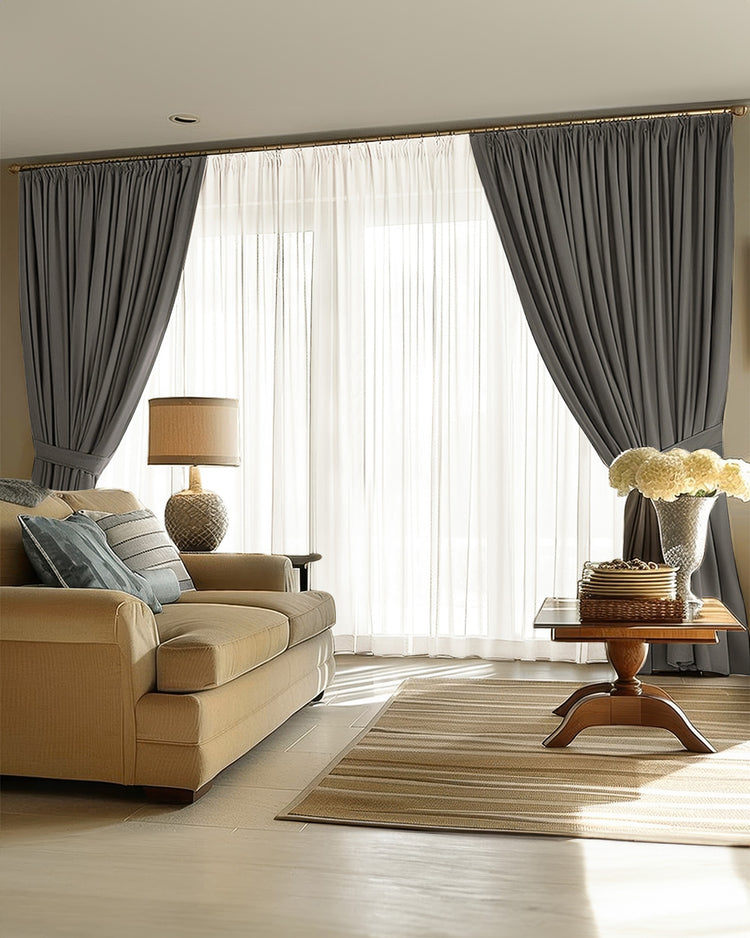 Pinch pleat dark grey linen blackout custom curtains tied back over sheer drapes for versatile light control.