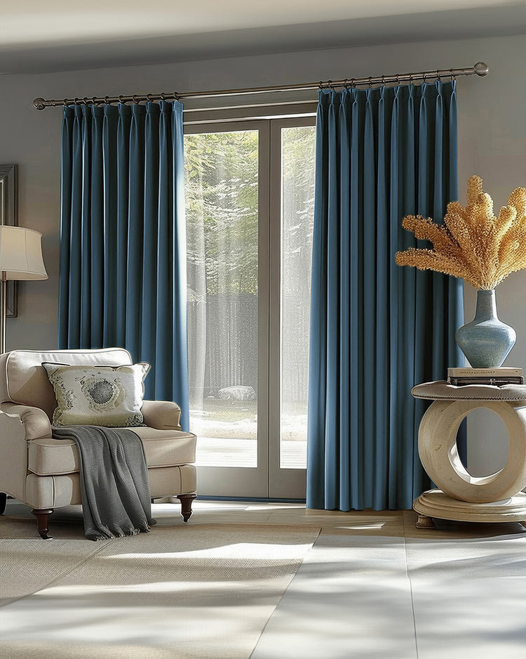 Victoria 100% Blackout OEKO linen look custom curtains in teal. Pleated drapes frame a window with armchair & decor.