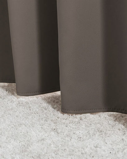 Hussein OEKO Certified custom curtain in charcoal, featuring its exquisitely tailored hemline resting gently on a plush white carpet.