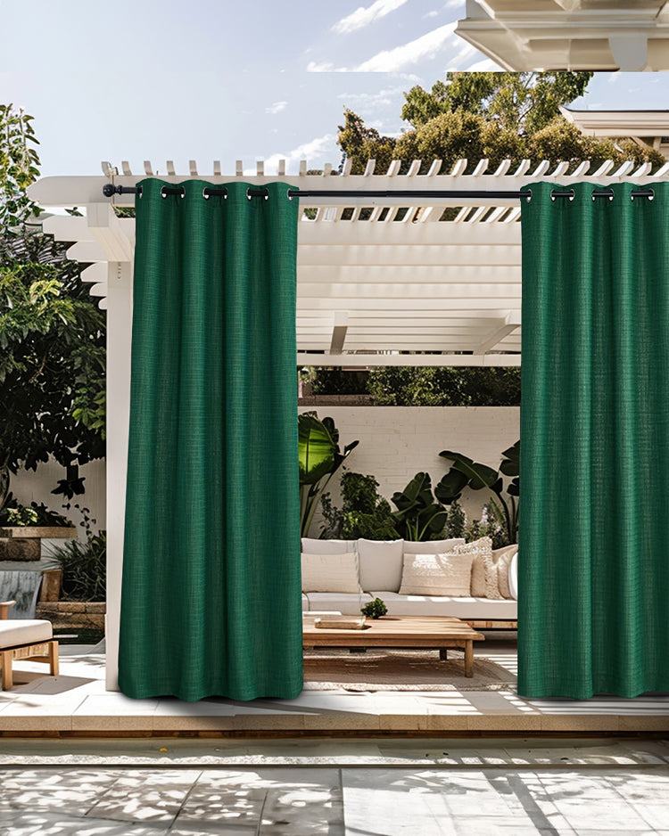 Bohemia emerald green waterproof custom outdoor curtains with crisscross woven texture, hanging from a white pergola over a patio.