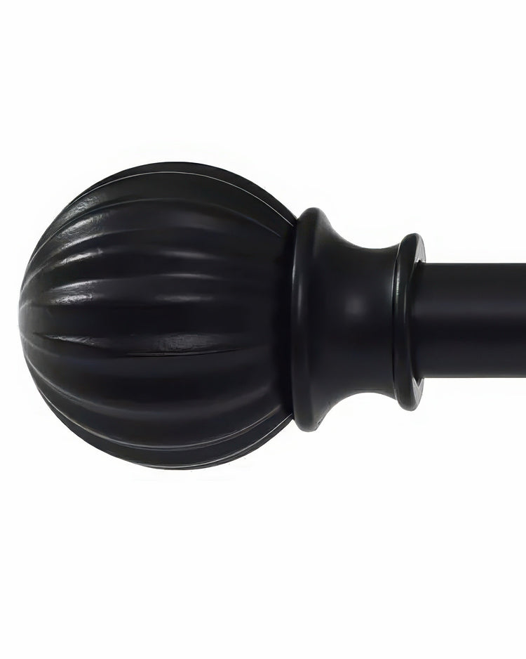 Matte black brass curtain rod finial with a decorative ribbed melon shape for window treatments.