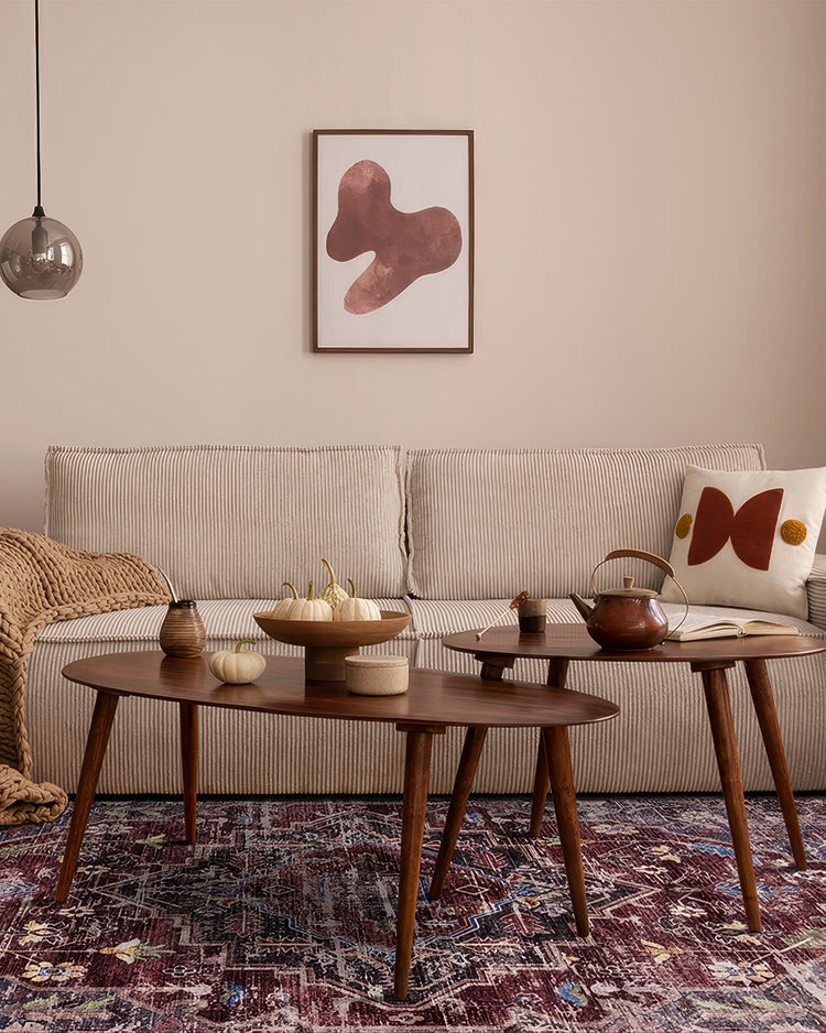 Diana's Garden washable area rug showcasing a distressed abstract pattern in deep reds, blues, & creams, anchoring a stylish living room.