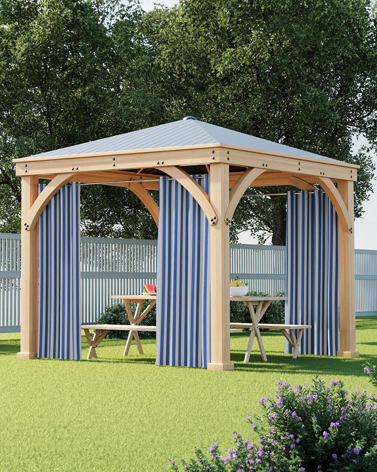 Lightweight, fade-resistant blue & white striped custom outdoor curtains on a wooden gazebo for a sunny yard setting.