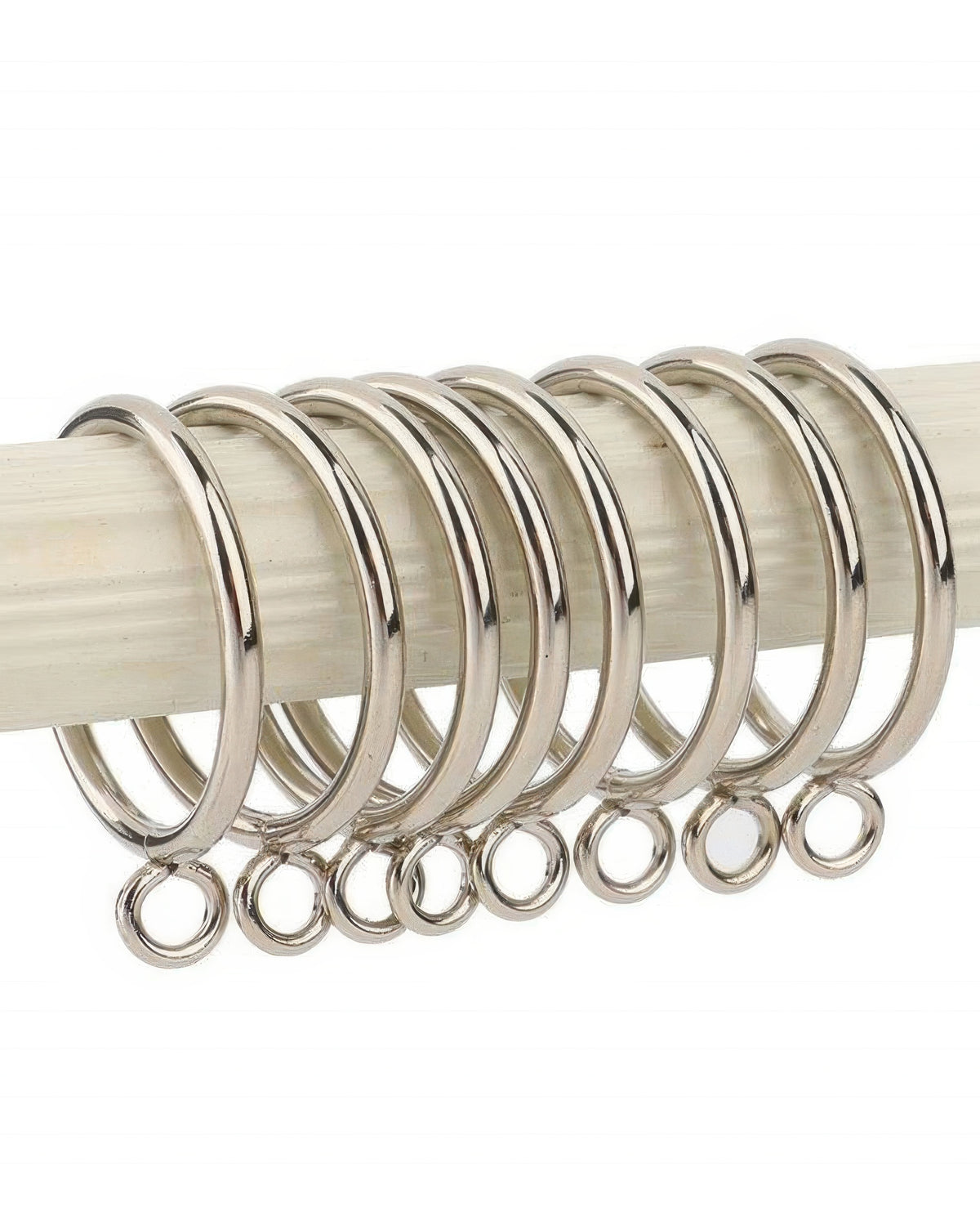 Close-up of polished silver metal curtain rings with eyelets on a rod, for custom drapery & window treatments.