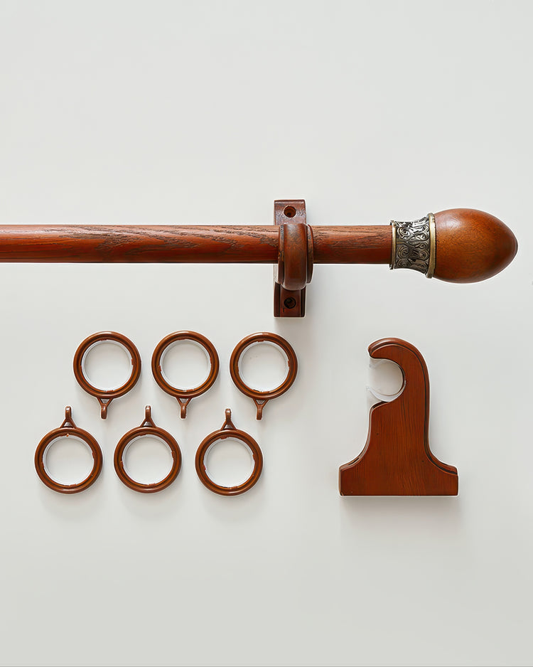 Rich brown carved wooden curtain rod with decorative finial, matching rings, bracket, and holdback for custom window treatments.
