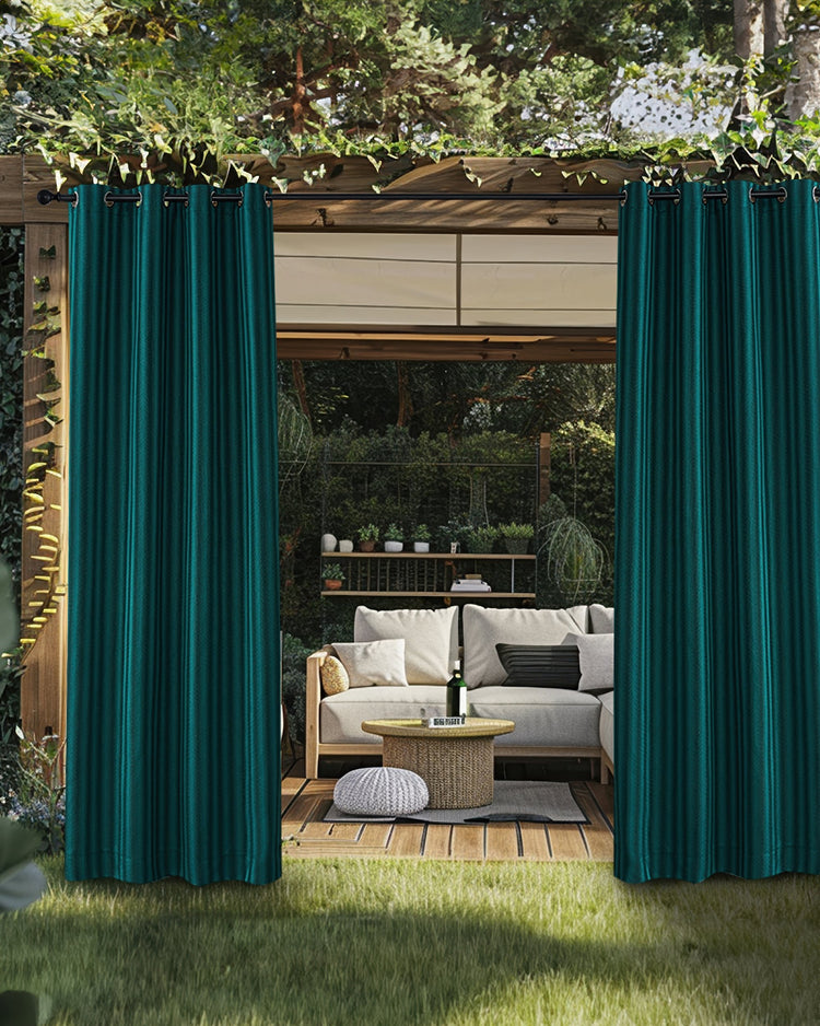 Miami Fishtail Patterned waterproof teal luxury custom outdoor curtains on a pergola, framing an outdoor lounge area.