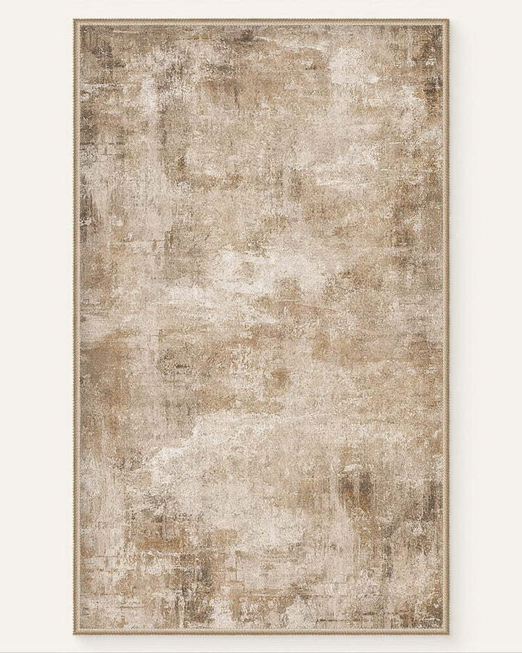Rectangular Mystic Clouds washable area rug featuring a distressed abstract pattern in shades of brown, beige, and cream with a braided border.