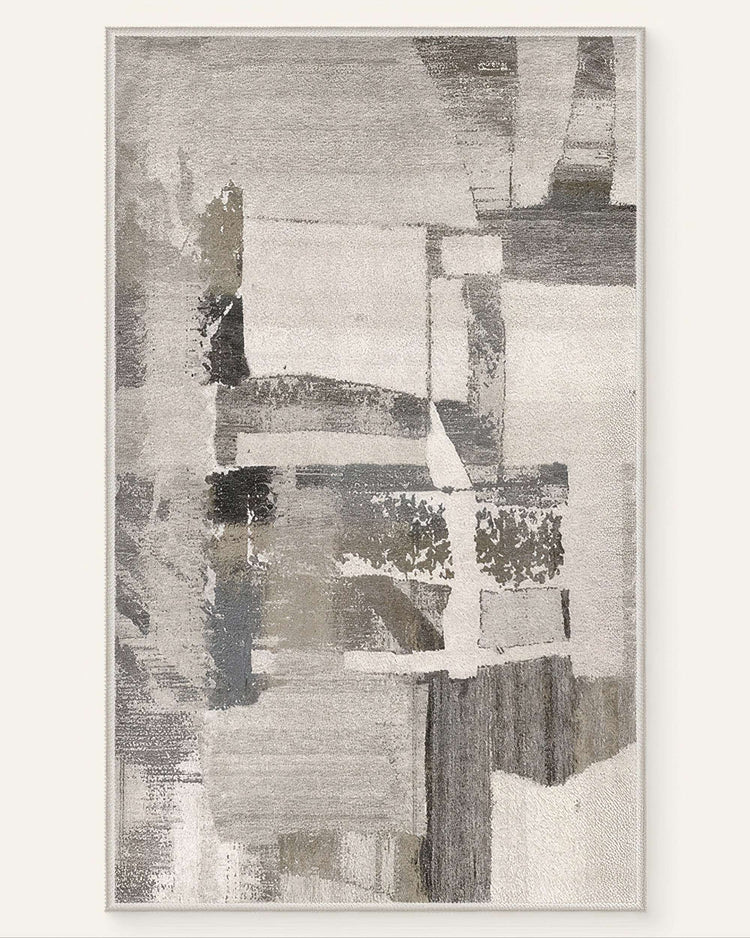 Abstract geometric vintage Tara washable area rug with grey, white, and subtle beige distressed pattern.