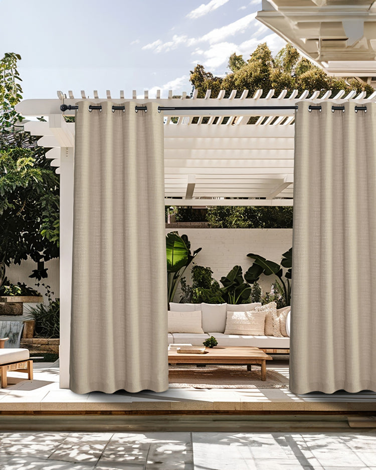 Custom beige textured waterproof outdoor curtains hanging from a pergola, enhancing a patio space with privacy.