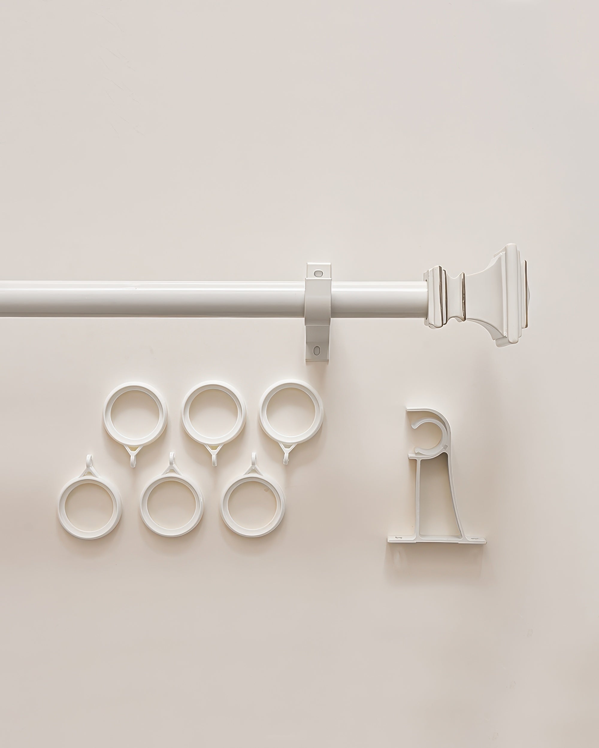 White Roman square custom curtain rod set with decorative finial, mounting bracket, and six matching drapery rings
