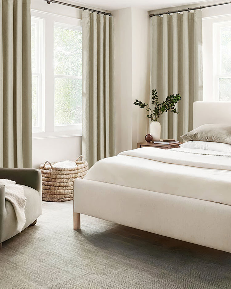 Light gray custom herringbone chenille blackout curtains framing a bedroom window, offering soundproof and thermal luxury for sophisticated decor.
