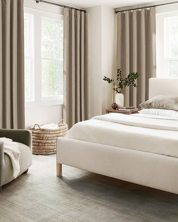 Elegant taupe Herringbone Chenille 100% blackout custom curtains in a bedroom, featuring ring top drapery for soundproof & thermal control.