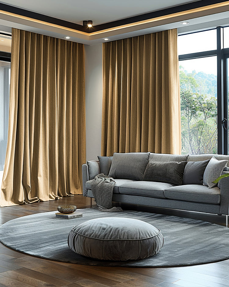 Luxurious brown velvet blackout custom curtains elegantly draped in a modern living room with a comfortable grey sofa.